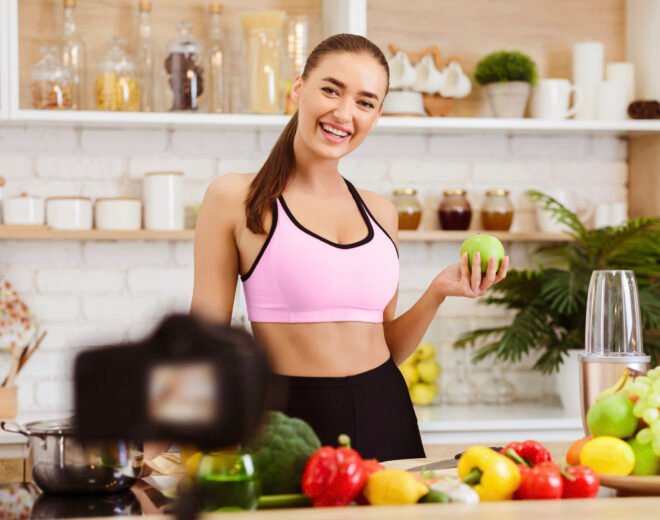 Young Sport Blogger Recording Video, Telling About Healthy Food In Kitchen